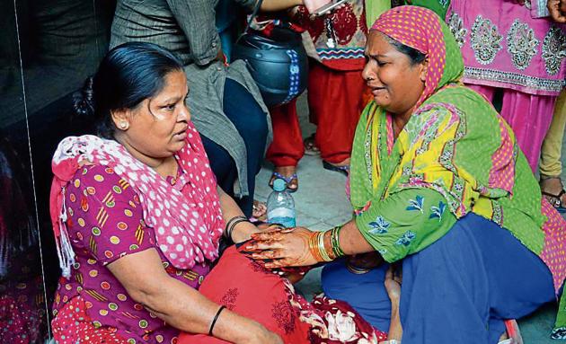 Family members of two brothers who died after inhaling toxic gases inside a sewer in east Delhi. Family members of two brothers who died after inhaling toxic gases inside a sewer in east Delhi.