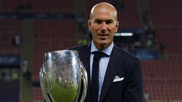 Real Madrid coach Zinedine Zidane as he celebrates winning the super cup final with the trophy. (REUTERS) Real Madrid coach Zinedine Zidane as he celebrates winning the super cup final with the trophy. (REUTERS)