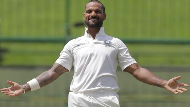India's Shikhar Dhawan celebrates scoring a century during the first day's play of their third cricket Test match against Sri Lanka. (AP)
