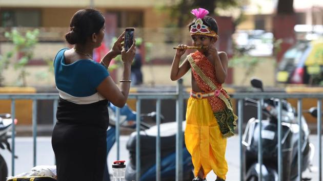 A woman takes a picture of her son dressed as Lord Krishna in Mumbai on Friday.(Satyabrata Tripathy/ HT Photo)