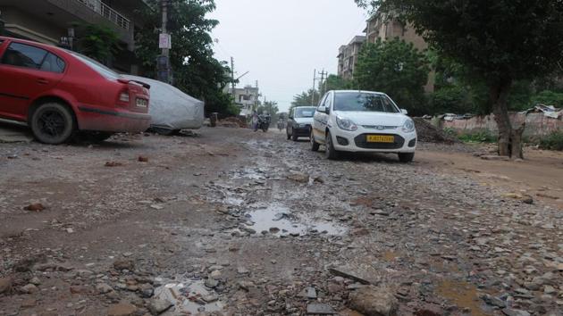 A badly damaged road in Sector 45 after Wednesday’s downpour. (Parveen Kumar/HT Photo) A badly damaged road in Sector 45 after Wednesday’s downpour. (Parveen Kumar/HT Photo)