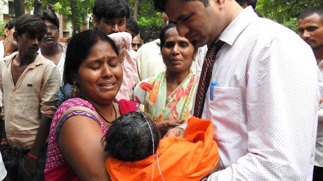 Relatives mourn the death of a child at the Baba Raghav Das Medical College hospital in Gorakhpur. (AFP Photo) Relatives mourn the death of a child at the Baba Raghav Das Medical College hospital in Gorakhpur. (AFP Photo)