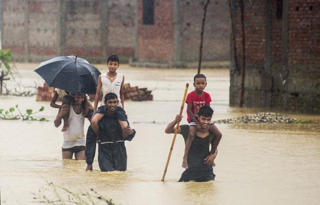 Nepalese men they wade through flood waters in Ramgadhwa village in Birgunj, Nepal on August 13, 2017. (AP) Nepalese men they wade through flood waters in Ramgadhwa village in Birgunj, Nepal on August 13, 2017. (AP)