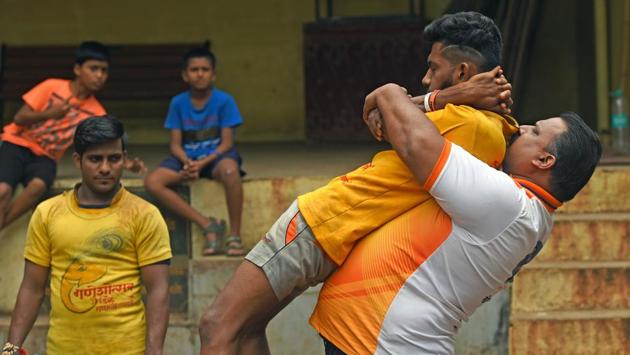 Coach Ganesh Chavan exercises with his teammates. (Pratik Chorge/HT) 