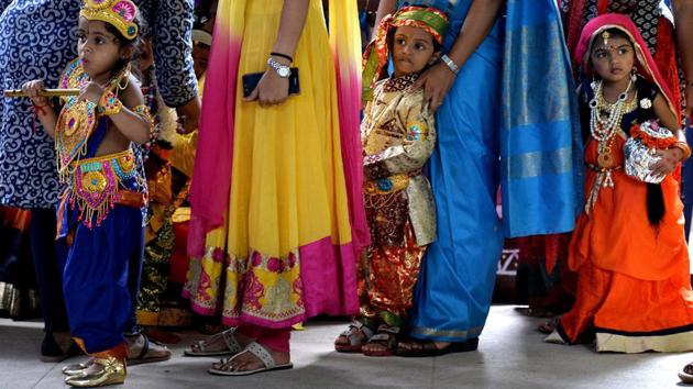 Indian children dressed as Hindu deity Krishna and his consort Radha stand in line with their mothers during an enactment competition as part of Krishna Janmashtami celebrations in Bangalore on August 12, 2017. (Manjunath Kiran/AFP)
