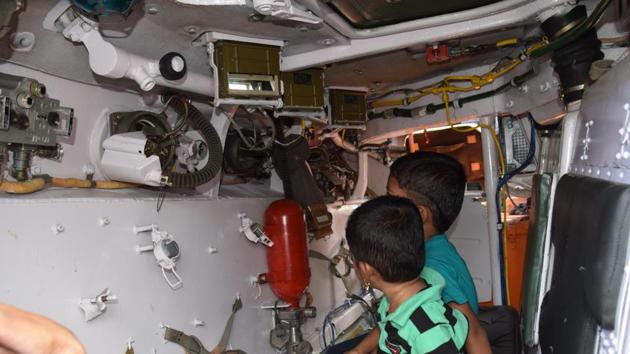 Schoolchildren inspect the interior of one of the vehicles showcased at the 'Know Your Army' exhibition. (HT PHOTO)