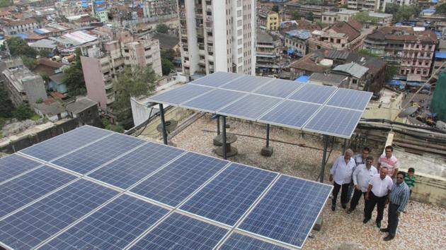 Residents with the solar panels. (Bhushan Koyande/HT) Residents with the solar panels. (Bhushan Koyande/HT)