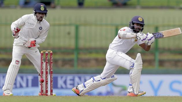 Sri Lanka's Niroshan Dickwella, right, plays a shot during the second day's play of their third cricket test match against India in Pallekele. (AP)