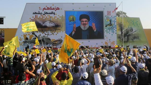 Supporters of Lebanon's Hezbollah leader Sayyed Hassan Nasrallah display Hezbollah and Lebanese flags as they listen to him via a screen during a rally in the southern village of Khiam. (Reuters Photo) Supporters of Lebanon's Hezbollah leader Sayyed Hassan Nasrallah display Hezbollah and Lebanese flags as they listen to him via a screen during a rally in the southern village of Khiam. (Reuters Photo)
