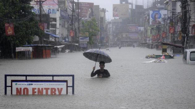An Indian man wades a flooded street during a heavy downpour in Agartala, the capital of northeastern state of Tripura on August 11, 2017. (Arindam Dey/AFP)