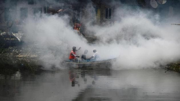 Indian health and municipal workers use a boat to help distribute pest-control chemicals to kill mosquitoes and larvae in Kolkata on August 9, 2017. Heavy monsoon rainfall across the eastern state of West Bengal has increased cases of vector-borne disease. (Dibyangshu Sarkar/AFP)