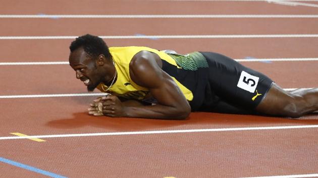 The legendary sprinter fell down on the track due to cramp. (REUTERS)