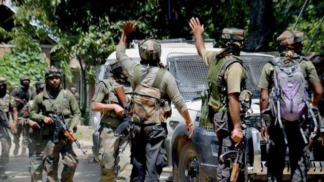 Army soldiers in action outside a house where militants were hiding during an encounter in which top three Hizbul Mujahideen Commanders and two Army soldiers were killed, at Awneera in Shopian district of south Kashmir on Sunday. (PTI Photo)