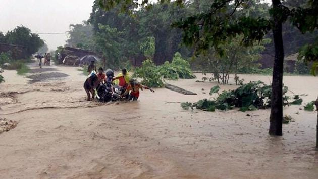 Villagers in a flood-hit area in Katihar district of Bihar on Sunday. (PTI)