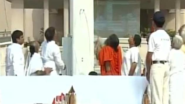 Ramdev hoisting the 100-ft flag at Patanjali Yogpeeth on Tuesday, August 15, 2017. (Screenshot from ANI video) Ramdev hoisting the 100-ft flag at Patanjali Yogpeeth on Tuesday, August 15, 2017. (Screenshot from ANI video)