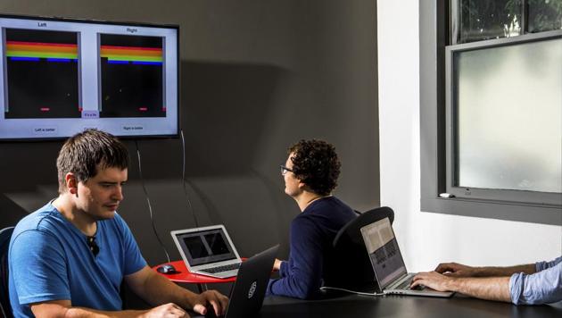 Geoffrey Irving and Dario Amodei show an autonomous system that has taught itself to play video games, at OpenAI in San Francisco, July 10, 2017.(NYT)