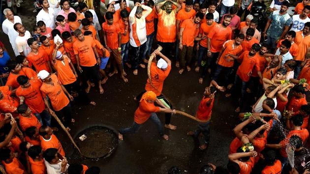 Govindas being lashed, as part of a 150-year-old tradition, at Panvel in Navi Mumbai. (Bachchan Kumar/HT PHOTO)