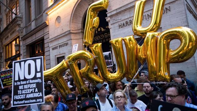 Protesters rally on Fifth Avenue near Trump Tower in New York City ahead of President Donald Trump's arrival on Monday.(AFP)