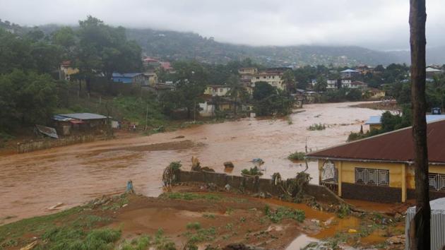 A torrent of water flows through a flooded neighbourhood in Regent, east of Freetown, Sierra Leone Monday, Aug. 14 , 2017.(AP)