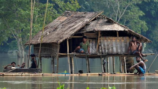 Villagers take shelter at a partially submerged house following floods at Baghmari village in Nagaon district, in the northeastern state of Assam, India August 15, 2017.(REUTERS Photo)