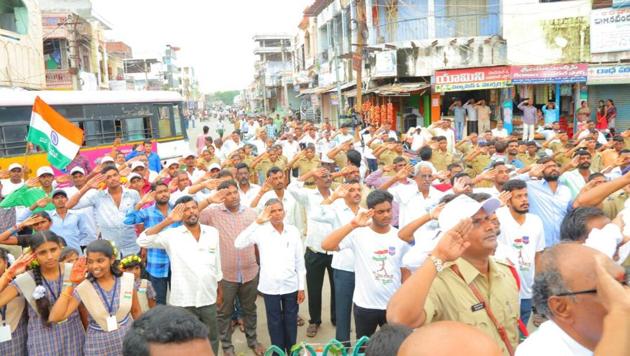 Jammikunta residents salute the national flag on Independence Day.(HT Photo)