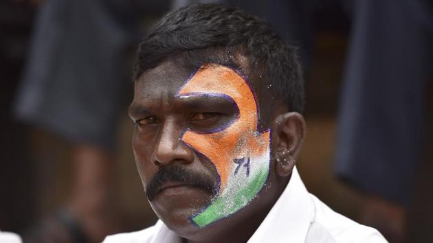 A spectator with his face painted  to resemble the Indian tricolour during Independence Day Cup in Bengaluru.  (Arijit Sen/HT Photo) 