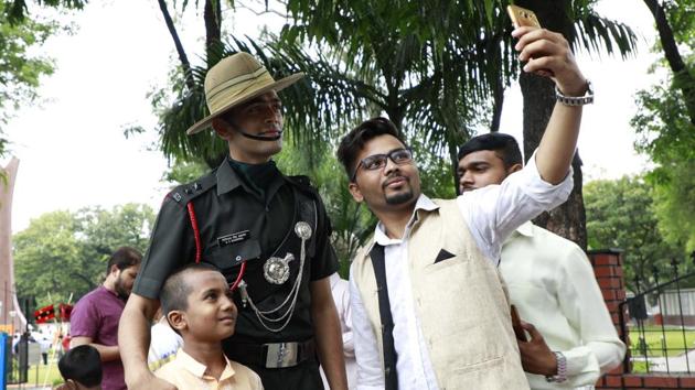 A man takes a selfie with army jawans at the Independence day celebrations at National War Memorial at camp in Pune. (Rahul Raut/HT PHOTO) 