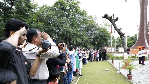 People salute at the flag hoist ceremony held at the Independence day celebration at the National War Memorial at camp  on Tuesday. (Rahul Raut/HT PHOTO) 