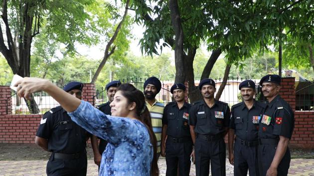 A woman takes a selfie with armymen at the Independence Day will be celebrations at National War Memorial in camp on Tuesday. (Rahul Raut/HT PHOTO) 