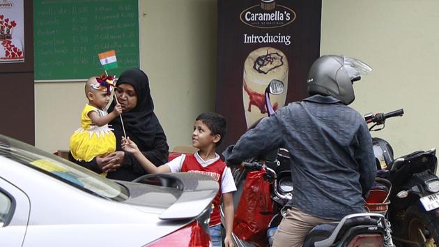 Pune, India - Aug. 14, 2017: Family travel a two wheeler on eve of Independence day at Karve nagar in Pune, India, on Monday, August 14, 2017. (Photo by Rahul Raut/HT PHOTO) (Rahul Raut/HT PHOTO) 