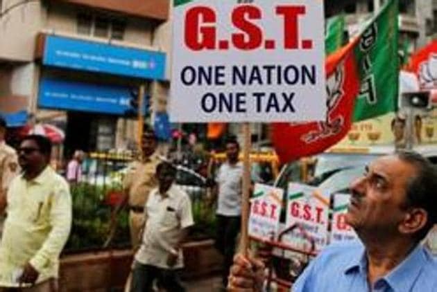 A BJP supporter holds a placard during a rally in favour of the goods and services tax.(Reuters file photo)