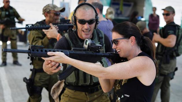 Foreign tourists are taught how to use a gun as they participate in a two hour anti-terror course at the Caliber 3 shooting range, near the West Bank settlement of Efrat. (AFP Photo) Foreign tourists are taught how to use a gun as they participate in a two hour anti-terror course at the Caliber 3 shooting range, near the West Bank settlement of Efrat. (AFP Photo)