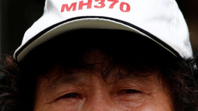A file photo of a family member of a passenger aboard Malaysia Airlines flight MH370 which went missing in 2014 during a protest outside the Chinese foreign ministry in Beijing on July 29, 2016. (Reuters) A file photo of a family member of a passenger aboard Malaysia Airlines flight MH370 which went missing in 2014 during a protest outside the Chinese foreign ministry in Beijing on July 29, 2016. (Reuters)