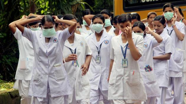 Paramedical students wear protective masks to protect themselves from swine flu as they enter a hospital in Bhubaneswar on Wednesday. (PTI) Paramedical students wear protective masks to protect themselves from swine flu as they enter a hospital in Bhubaneswar on Wednesday. (PTI)