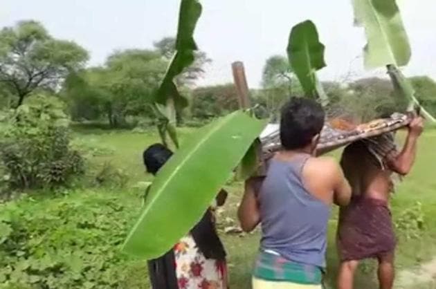 TV grab of Sahoo’s daughter, son and son-in-law carrying his body to the cremation ground after locals from the village refused to come forward and help. (HT Photo) TV grab of Sahoo’s daughter, son and son-in-law carrying his body to the cremation ground after locals from the village refused to come forward and help. (HT Photo)