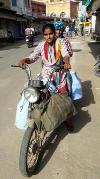 Neetu Sharma and her elder sister Sushma collect milk from houses in her village and then take it to Bharatpur city on a motorcycle for door-to-door delivery. (HT Photo) Neetu Sharma and her elder sister Sushma collect milk from houses in her village and then take it to Bharatpur city on a motorcycle for door-to-door delivery. (HT Photo)