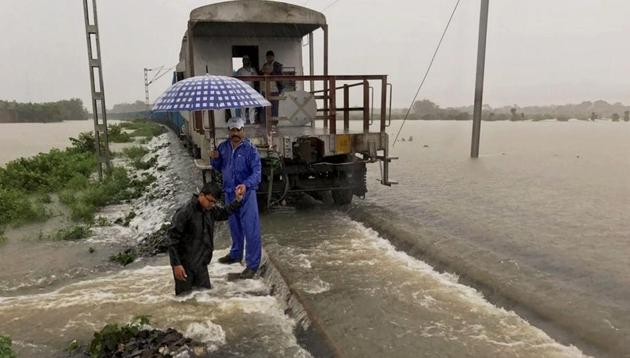 A goods train halts on the flooded tracks as railway employees inspect the damaged embankment along the Katihar-Guwahati line, in Katihar district of Bihar . (PTI photo) A goods train halts on the flooded tracks as railway employees inspect the damaged embankment along the Katihar-Guwahati line, in Katihar district of Bihar . (PTI photo)