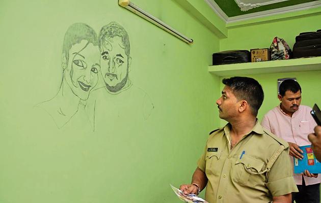 A policeman inspects the flat of the Rudrapur woman who was shot dead outside her society in Ghaziabad on Thursday afternoon. (Sakib Ali /HT) A policeman inspects the flat of the Rudrapur woman who was shot dead outside her society in Ghaziabad on Thursday afternoon. (Sakib Ali /HT)