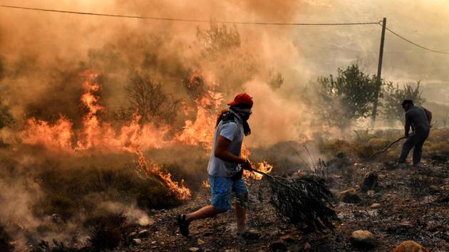 On Zakynthos, an island popular with foreign tourists, a dozen fires burned for a fifth day. Justice Minister Stavros Kontonis stated there was no doubt the fires had been set deliberately. The fire service said an incendiary device had been found in a forest on the island of Samos on Tuesday. (Aris Messinis / AFP)