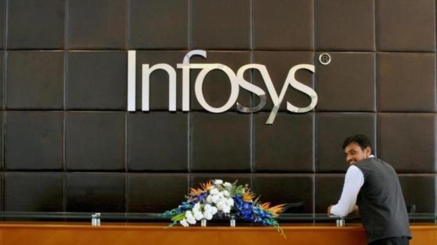 A file photo of an employee of Infosys stands at the front desk of its headquarters in Bengaluru.(Reuters) A file photo of an employee of Infosys stands at the front desk of its headquarters in Bengaluru.(Reuters)