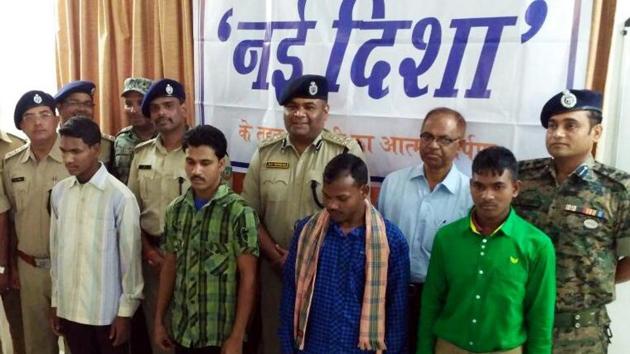 Senior police officials with four Maoists who surrendered in Lohardaga on Wednesday (HT Photo) Senior police officials with four Maoists who surrendered in Lohardaga on Wednesday (HT Photo)