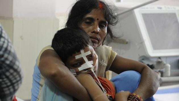 A woman with her son affected by encephalitis at the BRD medical college in Gorakhpur on Tuesday. (Deepak Gupta/HT Photo) A woman with her son affected by encephalitis at the BRD medical college in Gorakhpur on Tuesday. (Deepak Gupta/HT Photo)