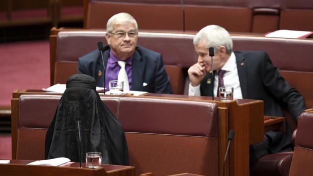 Pauline Hanson, bottom left, wears a burqa during question time in the Senate chamber at Parliament House in Canberra, Australia. (AP) Pauline Hanson, bottom left, wears a burqa during question time in the Senate chamber at Parliament House in Canberra, Australia. (AP)