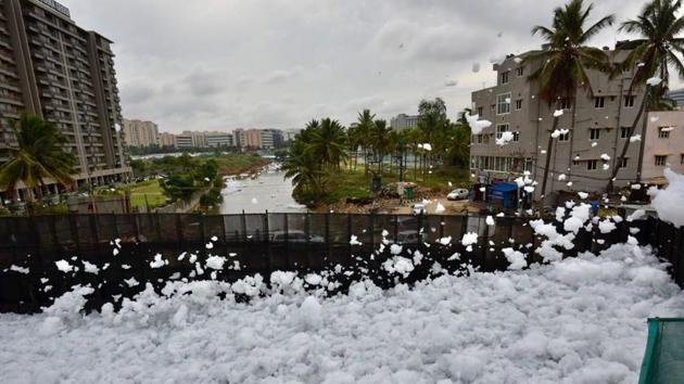 The New Indian Express reported that the city’s fire department was sprinkling water on Wednesday to control froth from spilling over to the main road and residents reported a terrible stink from the lake. (Arijit Sen/HT Photo)