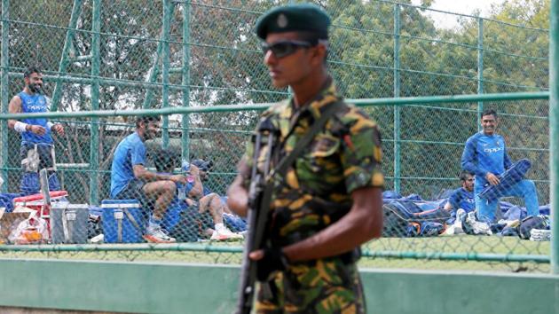 Virat Kohli and his teammate MS Dhoni share a moment with their teammates as a Special Task Force soldier stands guard next to them. (REUTERS) Virat Kohli and his teammate MS Dhoni share a moment with their teammates as a Special Task Force soldier stands guard next to them. (REUTERS)
