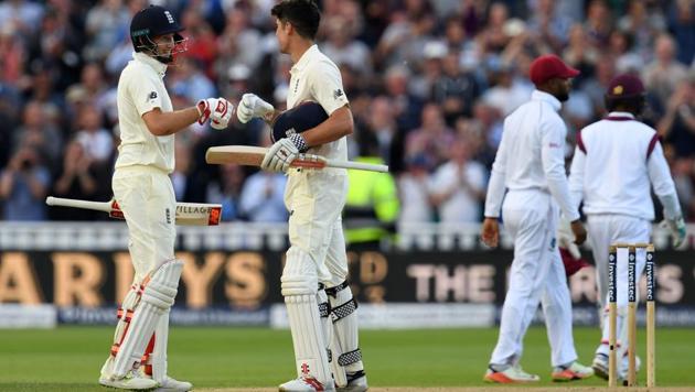 Alastair Cook is congratulated by England's captain Joe Root (L) after reaching his century during play on the opening day of the first cricket Test between England and the West Indies at Edgbaston in Birmingham on Thursday. England won the toss and elected to bat in the first day-night Test ever staged on English soil . (AFP) Alastair Cook is congratulated by England's captain Joe Root (L) after reaching his century during play on the opening day of the first cricket Test between England and the West Indies at Edgbaston in Birmingham on Thursday. England won the toss and elected to bat in the first day-night Test ever staged on English soil . (AFP)