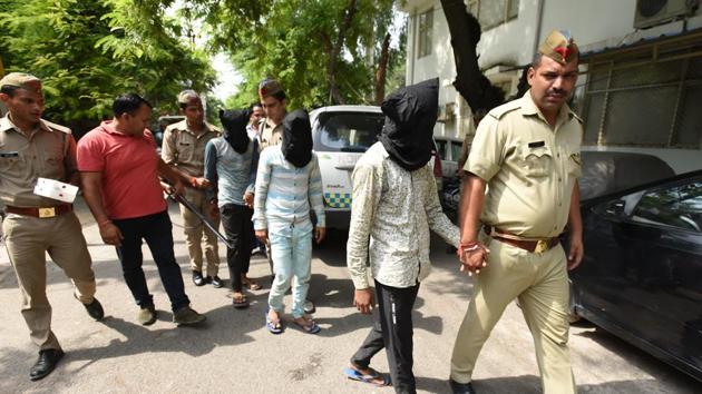 The arrested men in police custody on Friday (Virendra Singh Gosain/HT PHOTO) The arrested men in police custody on Friday (Virendra Singh Gosain/HT PHOTO)