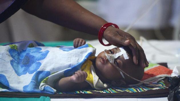 A woman looks after her child at the encephalitis ward of the Baba Raghav Das Medical College in Gorakhpur.(AFP Photo) A woman looks after her child at the encephalitis ward of the Baba Raghav Das Medical College in Gorakhpur.(AFP Photo)