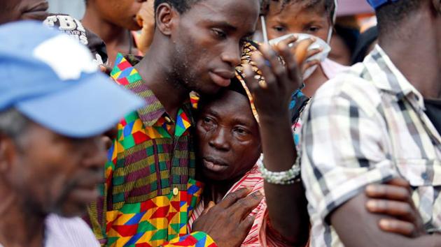 A mother who lost her son during the mudslide is consoled by a sympathiser near the entrance of Connaught Hospital in Freetown, Sierra Leone. The mudslide which occurred after three days of torrential downpour overwhelmed the city’s drainage creating waterways that funnelled mud through the city’s roads. (Afolabi Sotunde / REUTERS)
