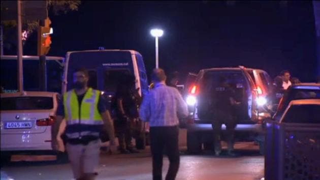 Officers investigate at the scene where police killed four attackers in Cambrils, south of Barcelona, in this still image taken from Reuters video on Friday. (Reuters) Officers investigate at the scene where police killed four attackers in Cambrils, south of Barcelona, in this still image taken from Reuters video on Friday. (Reuters)